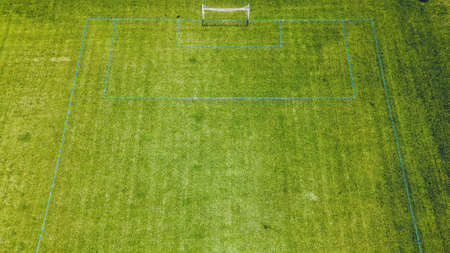 Fresh green grass is growing on the soccer fields at a local parkの写真素材