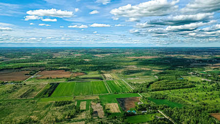 A beautiful sky hovers over a under developed area of Wisconsin. Farm lands around the forests with new houses. A beautiful view for sure!の写真素材