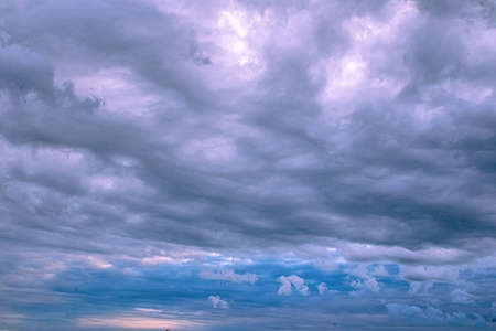 Summertime storm clouds loom overhead threatening rain and storms