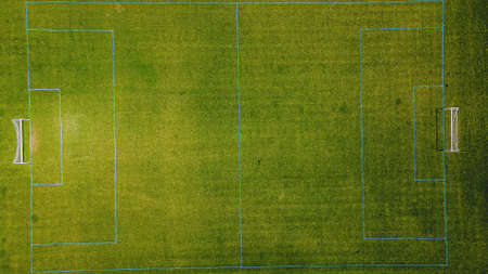 Fresh green grass is growing on the soccer fields at a local parkの写真素材