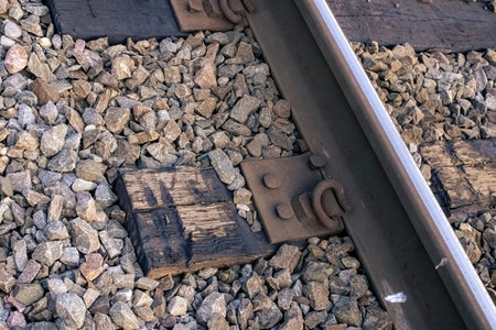 A view of the train tracks up close near the rocks and railsの写真素材