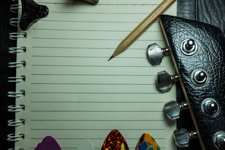 pick guitar and blank notebookの写真素材