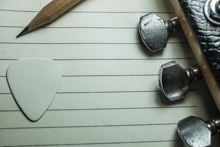 pick guitar and blank notebookの写真素材