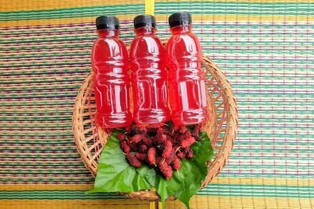 Refreshing mulberry juice in the bottles with berries on table, Healthy fruit, Organic fresh.-Healthy concept.の写真素材