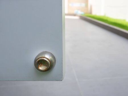 stainless magnetic door stopper, defect with rust around door stopper, Outdoor area.の写真素材