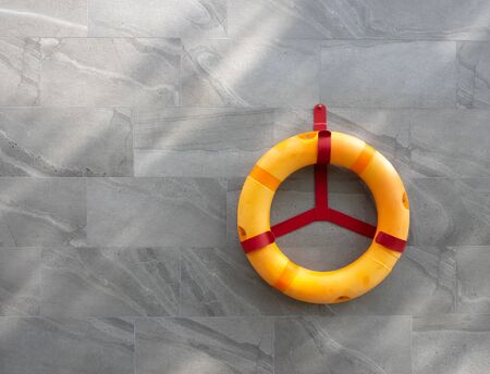 lifebuoy is hanging on the steel, rescue equipment for swimming pool, help and safety, blank space...