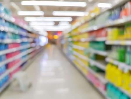 Row variety consumer product on shelves in store at supermarket, concept blurred background.