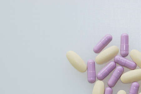 Multivitamins and supplements on white background, Including Vitamin c, vitamin E, top view.