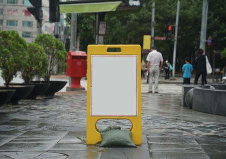 A picture of an empty warning board neck-up on a rainy dayの写真素材