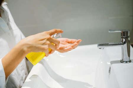 female using alcohol antiseptic gel to cleaning handの写真素材