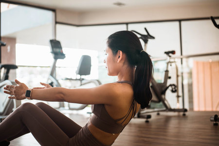 young women doing exercise abdominal crunches in the gymの写真素材
