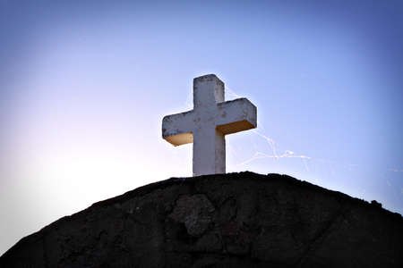 white cross with spiderwebs on top of tombstoneの写真素材