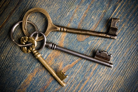 three keys on wooden table