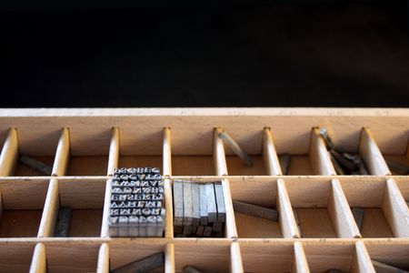 a wood type drawer with metal type against a black backgroundの写真素材