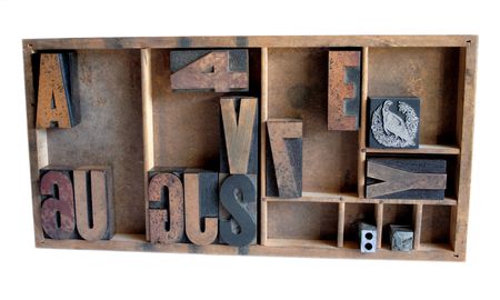 wood type, metal printer's cuts and a metal spacing piece in a type case