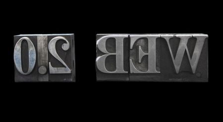old letterpress metal type letters form the term 'WEB 2.0', isolated on blackの写真素材