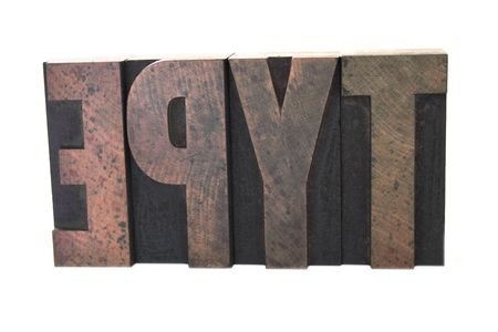 old, inkstained wood letterpress letters form the word 'type' in all caps isolated on whiteの写真素材