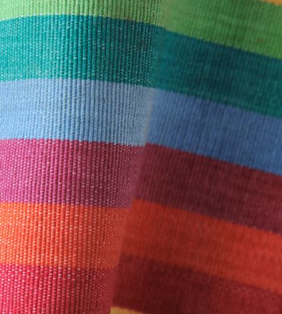 curving fabric in bright, cheerful rainbow shadesの写真素材