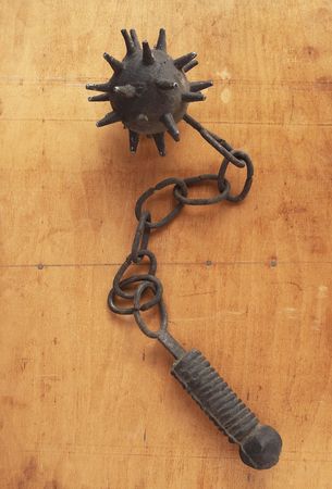 flail on a wood backgroundの写真素材