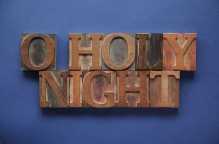 the words O holy night in old ink-stained letterpress wood typeの写真素材