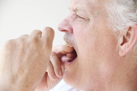 a senior man practices good dental hygiene