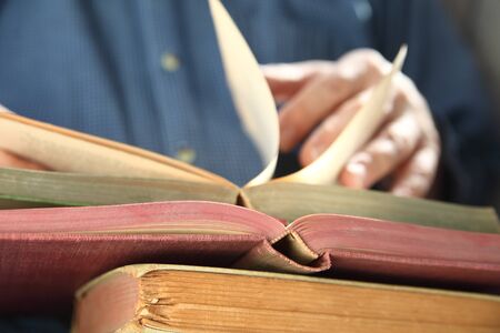 a man looks through an old book