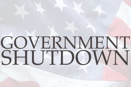 the words government shutdown on an old USA flagの写真素材