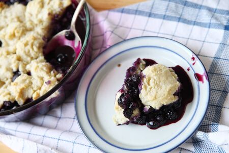 Cobbler made with fresh blueberries a portion served on a dishの写真素材