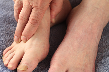 A man with his hand on one footの写真素材