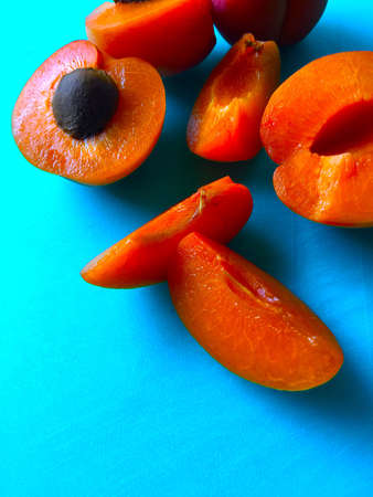 Apricots cut up on a blue background with room for textの写真素材