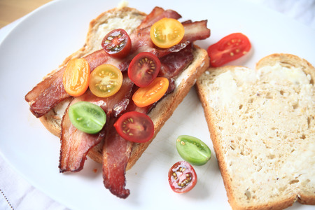 Bacon and cherry tomato sandwich on white bread with mayonnaiseの写真素材