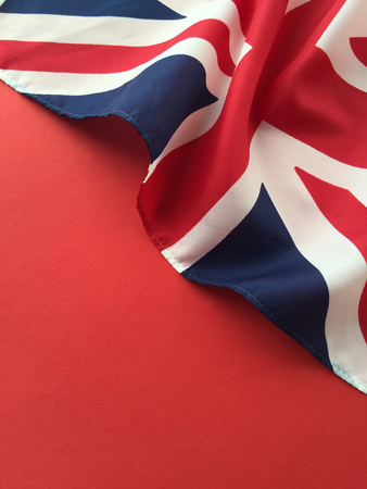 Draped UK flag on a red background with room for textの写真素材