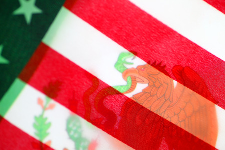 One countryâs flag seen behind the otherの写真素材