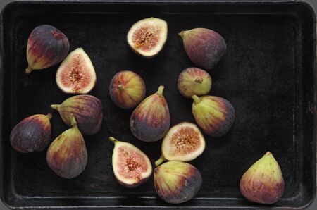 Fresh figs, whole and halves with room for textの写真素材