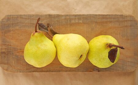 Three pears on a piece of weathered wood with room for textの写真素材