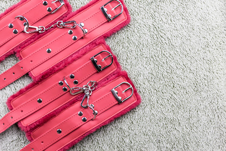 Red straps are handcuffs for love games.の写真素材