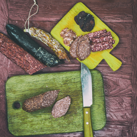 Smoked sausages are cut on a cutting board.の写真素材