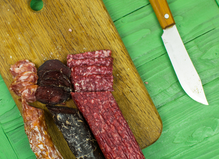 Smoked sausages are cut on a cutting board.の写真素材