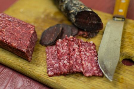 Smoked sausages are cut on a cutting board.の写真素材