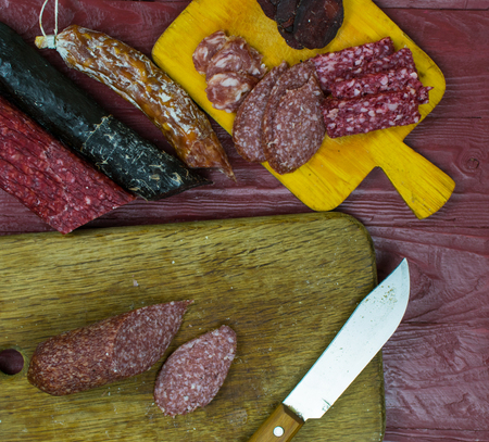 Smoked sausages are cut on a cutting board.の写真素材