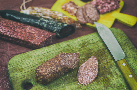 Smoked sausages are cut on a cutting board.の写真素材