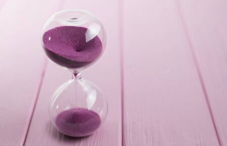 Hourglass with pink sand.の写真素材
