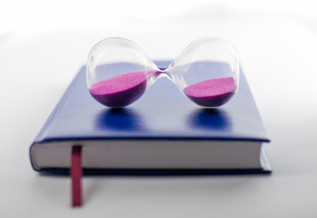 Time planning. Hourglass and business diary.の写真素材