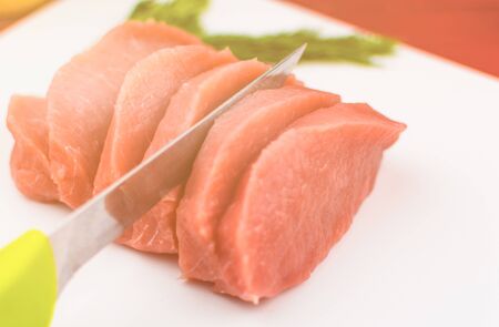 Pork fillets slice into pieces on a white background. Toned.の写真素材
