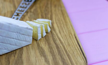 Sliced brie cheese on a wooden background.の写真素材