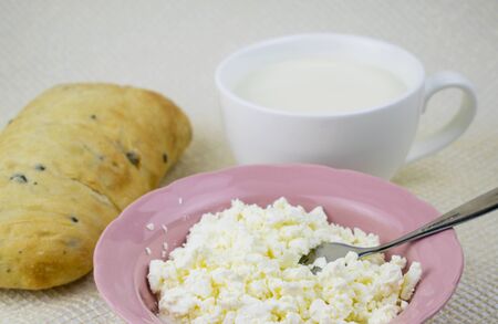A set of dairy products and bread on a light background.の写真素材