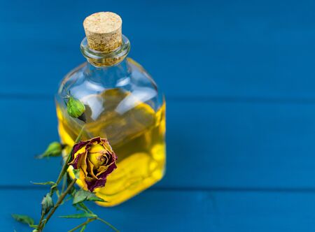 Bottle with elixir on a blue wooden background.の写真素材