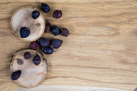 Berries of a dogrose on a wooden background.の写真素材