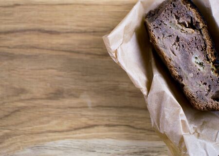 A piece of homemade pie on a wooden background.の写真素材