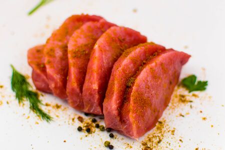 Pork fillet chopped spices on a white background.の写真素材